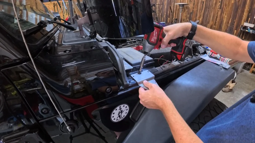 Driving a self-tapping screw into the Topsy antenna bracket.