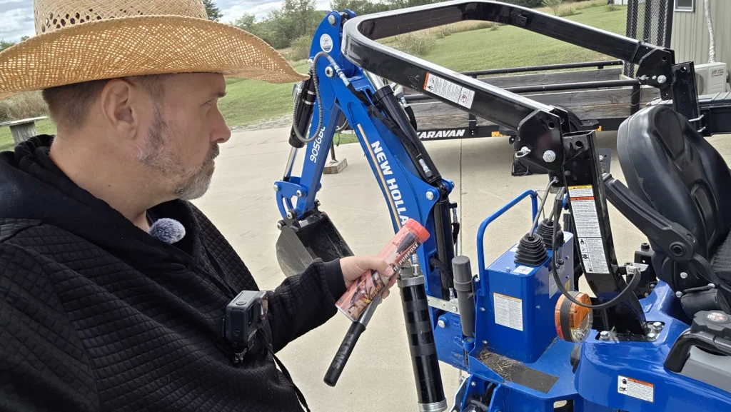 ryan greasing new holland backhoe